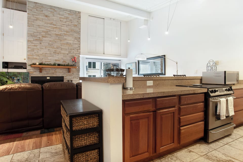 Open living room/dining room/kitchen floor plan with high vaulted ceilings.