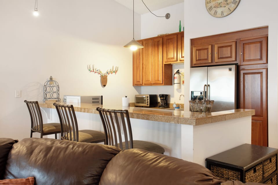 Fully stocked kitchen with everything needed for cooking. (old couch in photo)