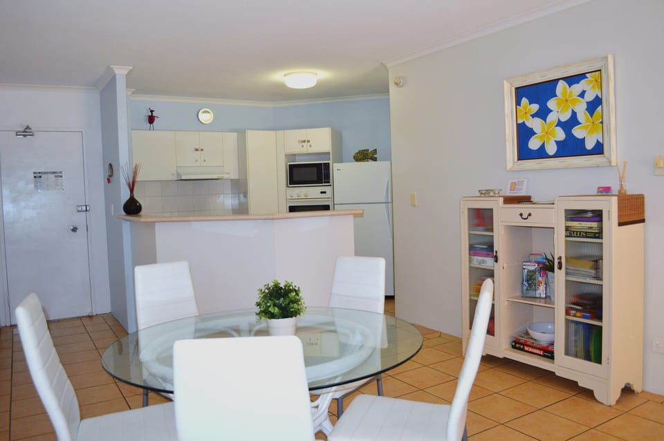 Dining area looking to full kitchen. Cupboard, right, stores games, books etc

