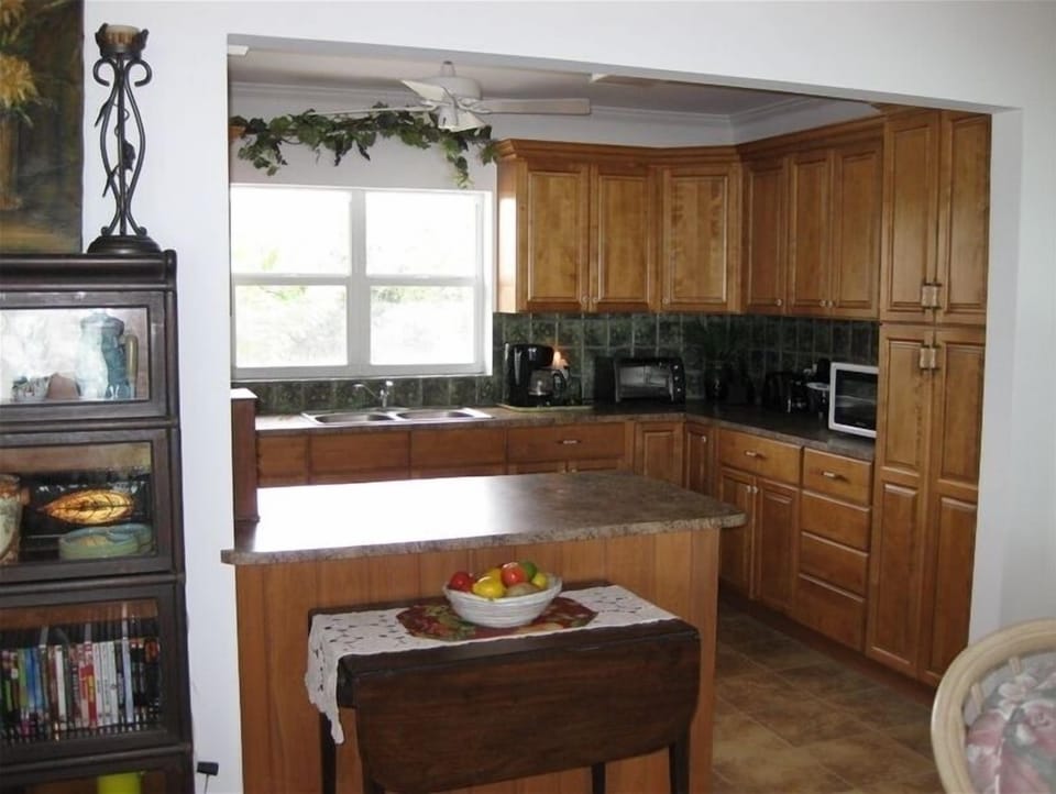 Kitchen open to seaview.  Extensive cooking equipment.  Window overlooks garden.