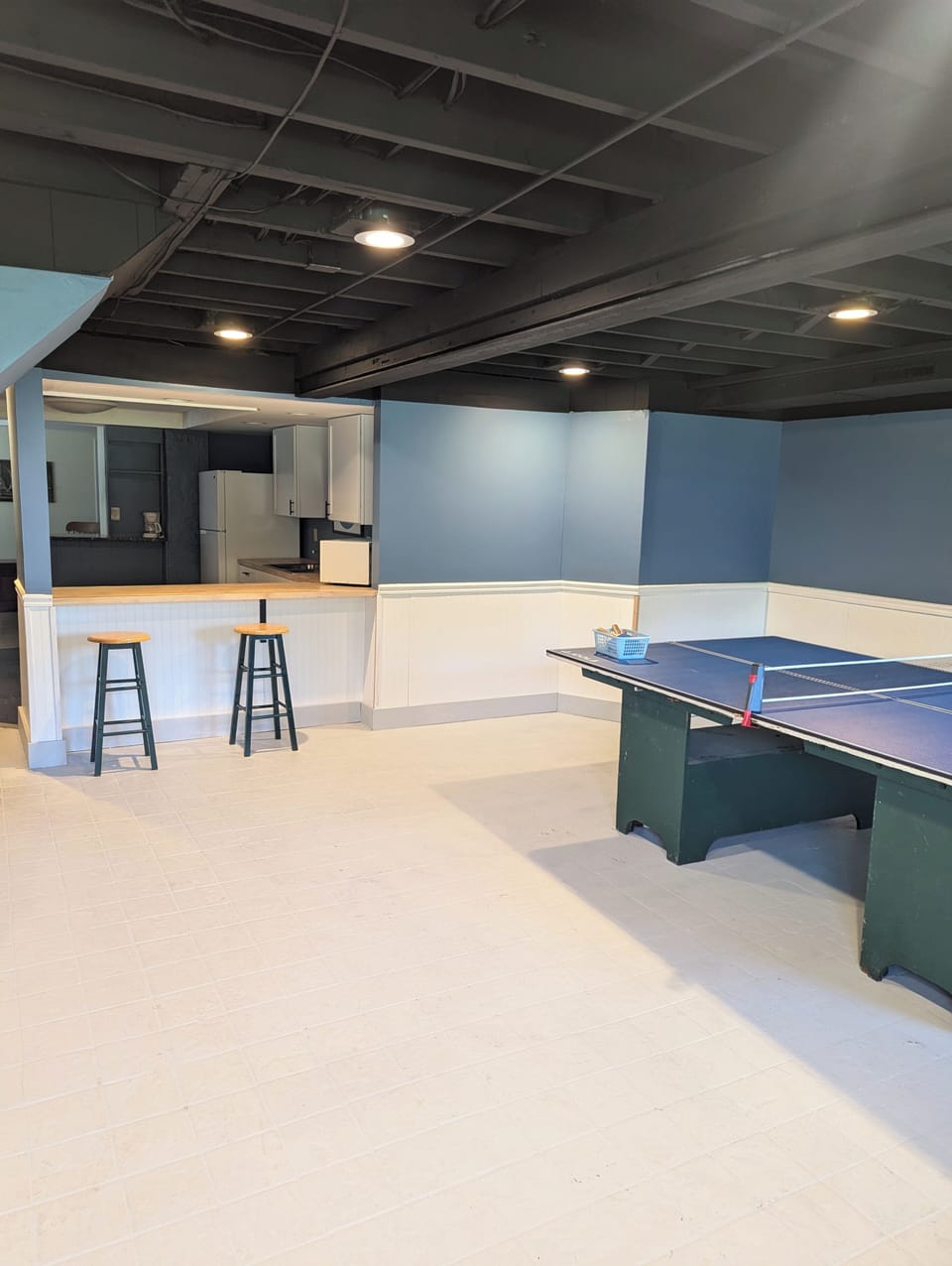 Game room with ping pong table with pass through to kitchenette.  Foosball too.