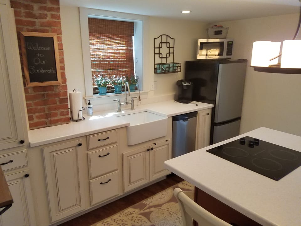 modern kitchen equipped with range, fridge, microwave, coffee maker, dishwasher