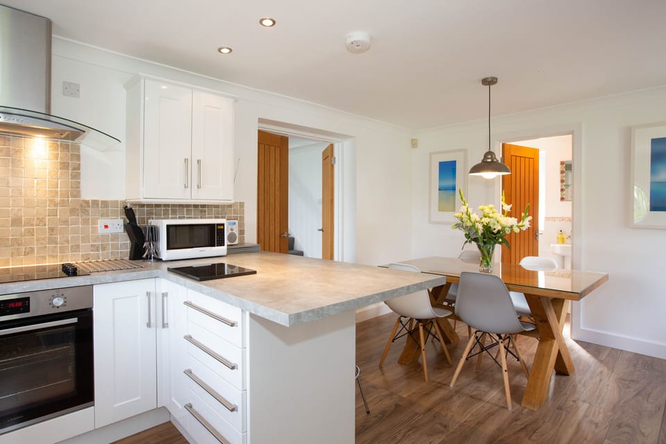 The well-equipped kitchen diner, with access to downstairs cloakroom.