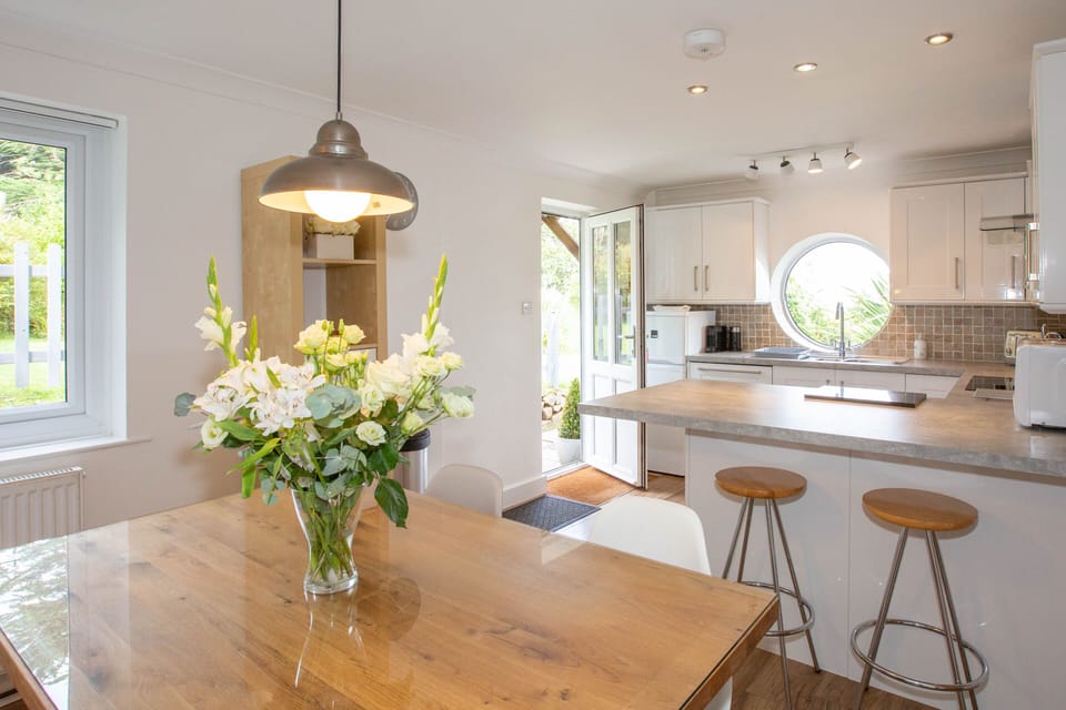 The dining area has a chunky solid oak dining table and seating fro up to five.