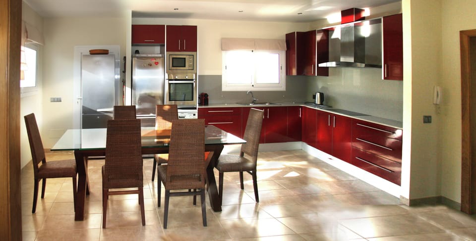 Large, modern kitchen with plenty of storage space & comfortable dining area. 