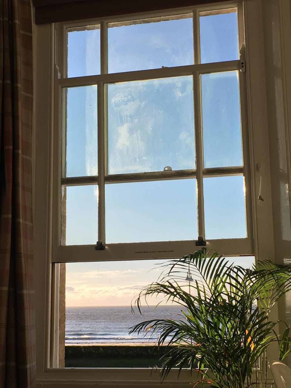 view of the sea from the double bedroom with our tall elegant window open.