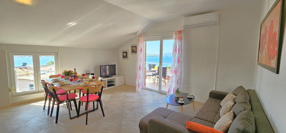 Open plan living/dining and kitchen area opening into sea view terrace