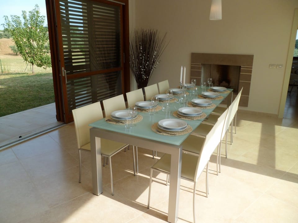 Indoor dining with glass doors to pool terrace
