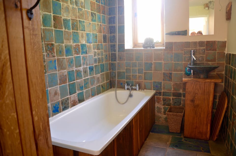 Good sized family bathroom next to both twin rooms, with overhead shower