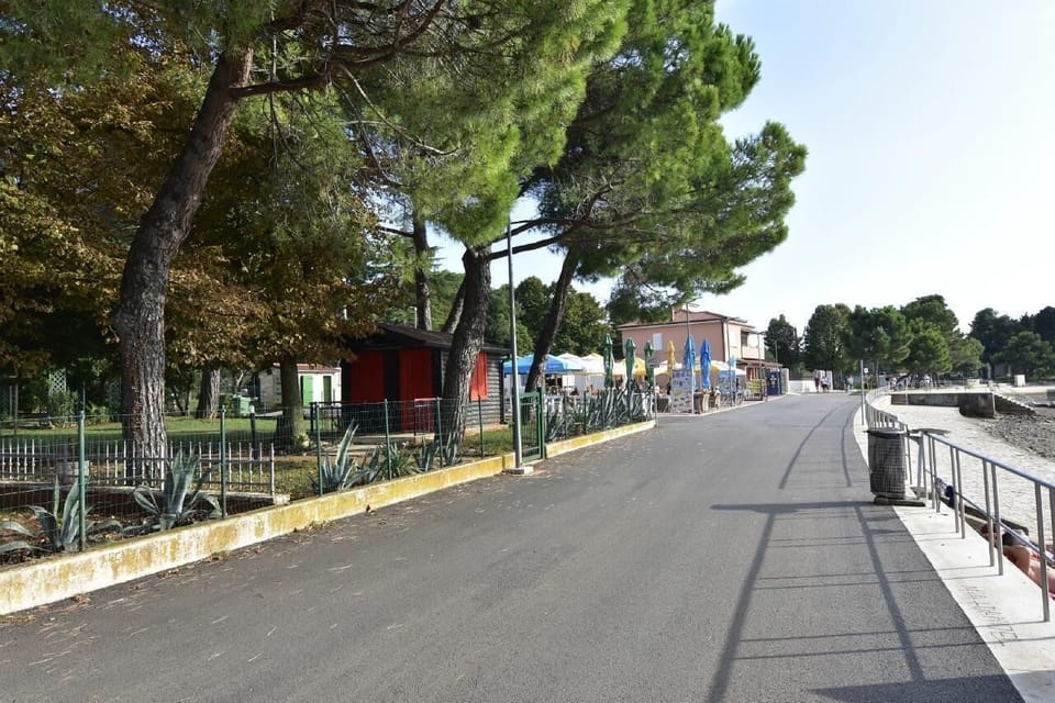The promenade by the sea with bars and fast-food restaurants attached to the beach of Villa Rita