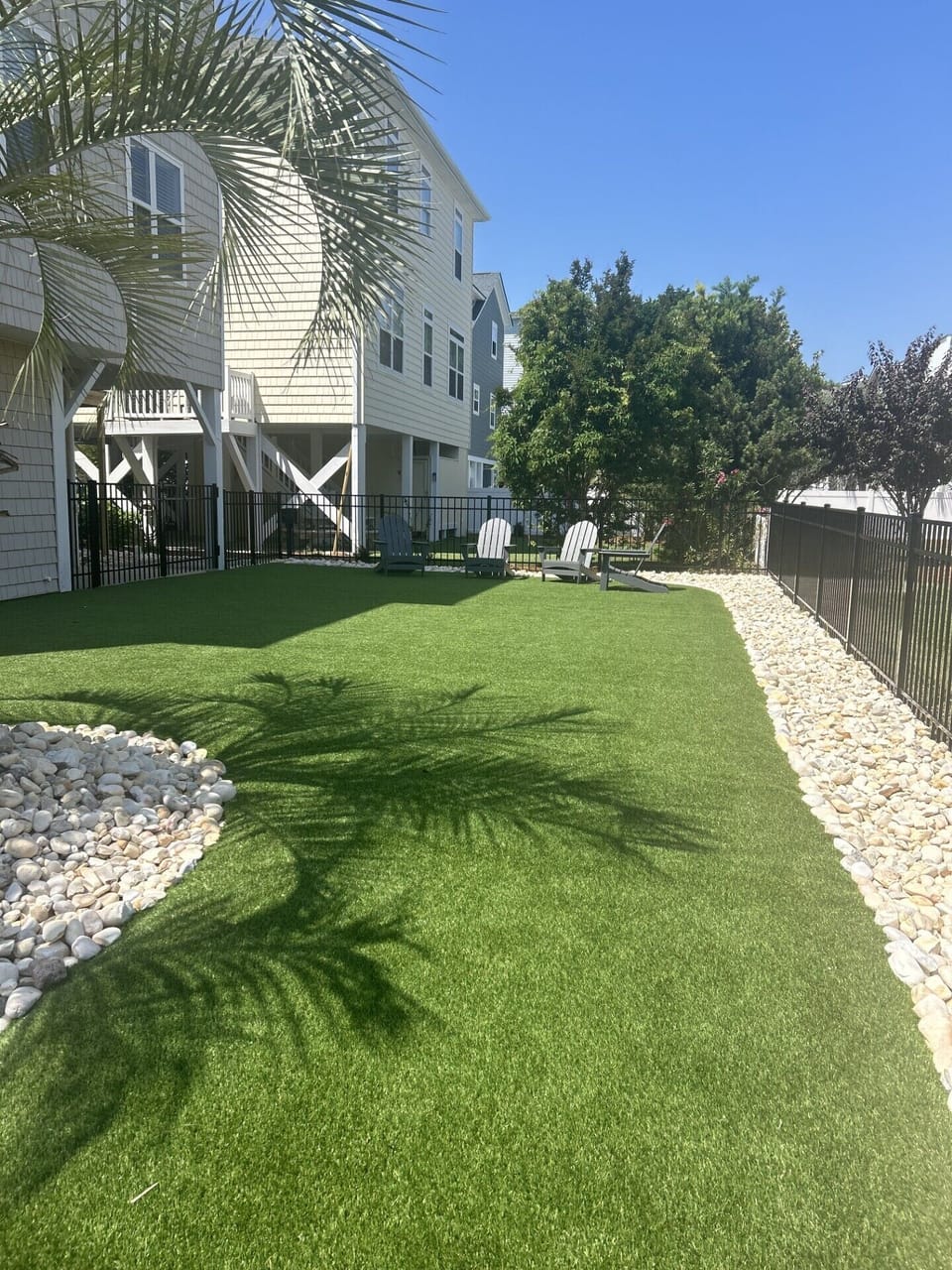 Fenced backyard w/artificial turf

