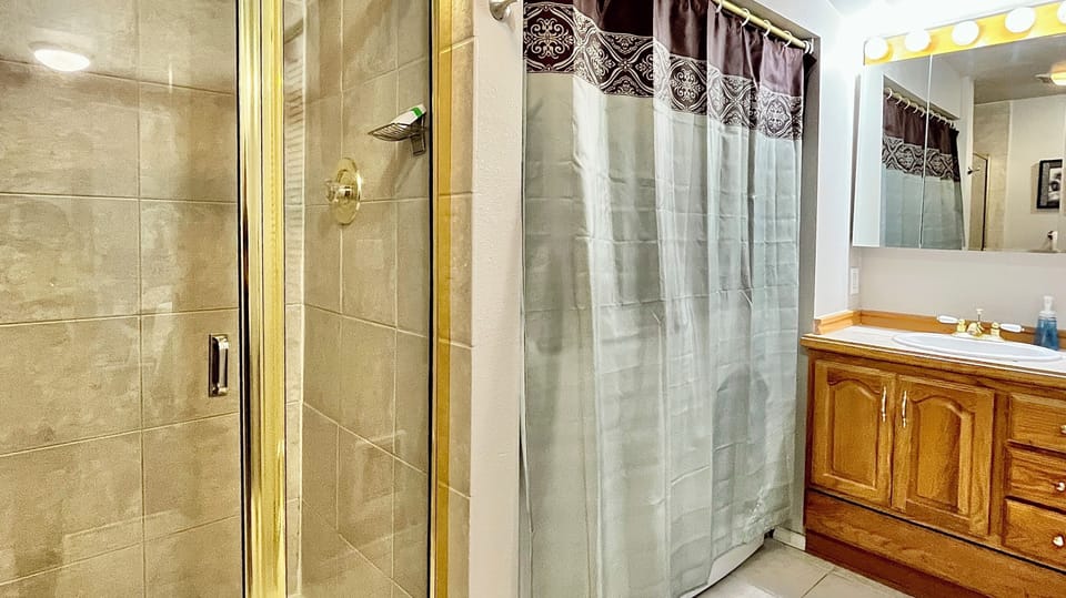 Master bathroom with shower and full-sized washer/dryer