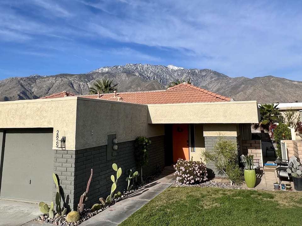 The house with the mountains in the background