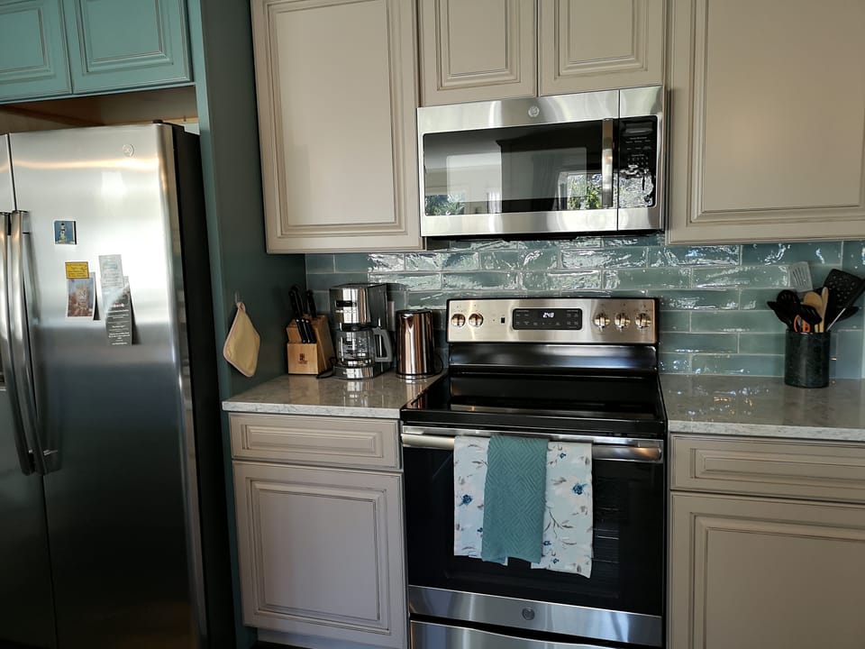 Signature hand crafted cabinets, tile backsplash, new hardware and fixtures