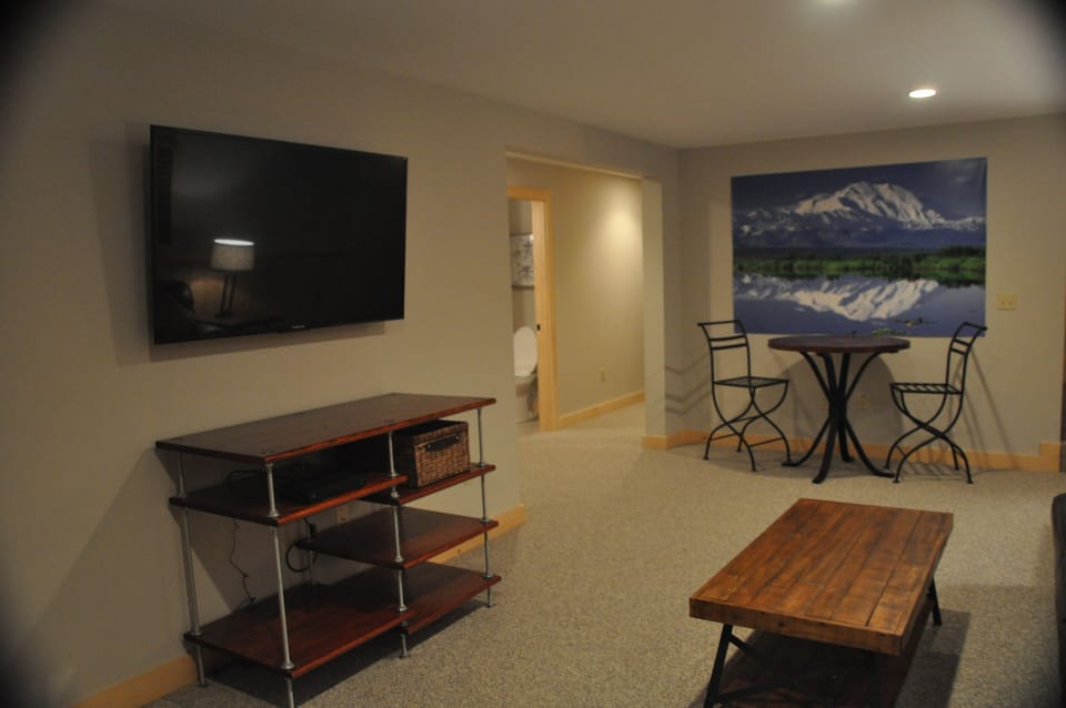 Basement entertainment area with 55in UHD TV and Xbox 