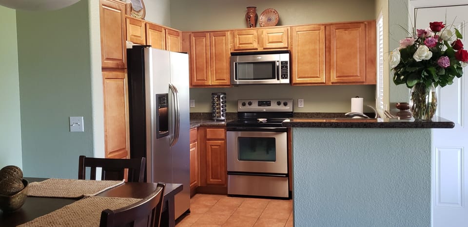 Granite counters in kitchen. Frig with water and ice.