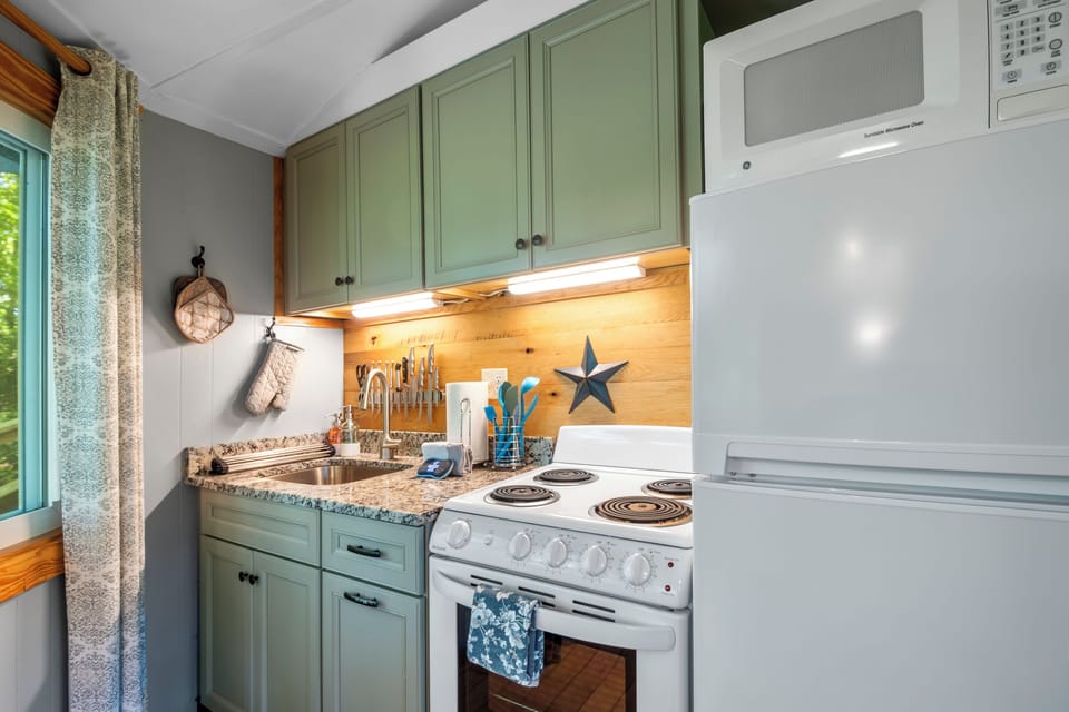 Fully equipped kitchen featuring modern appliances, granite countertops, and stunning mountain views.