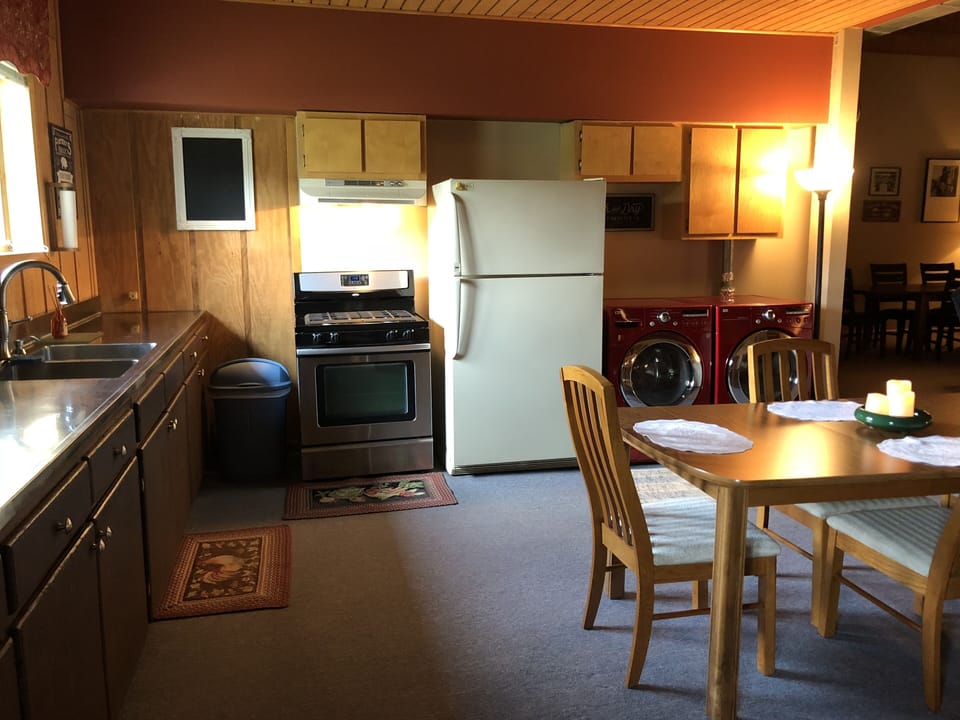 Gas stove with commercial size refrigerator.