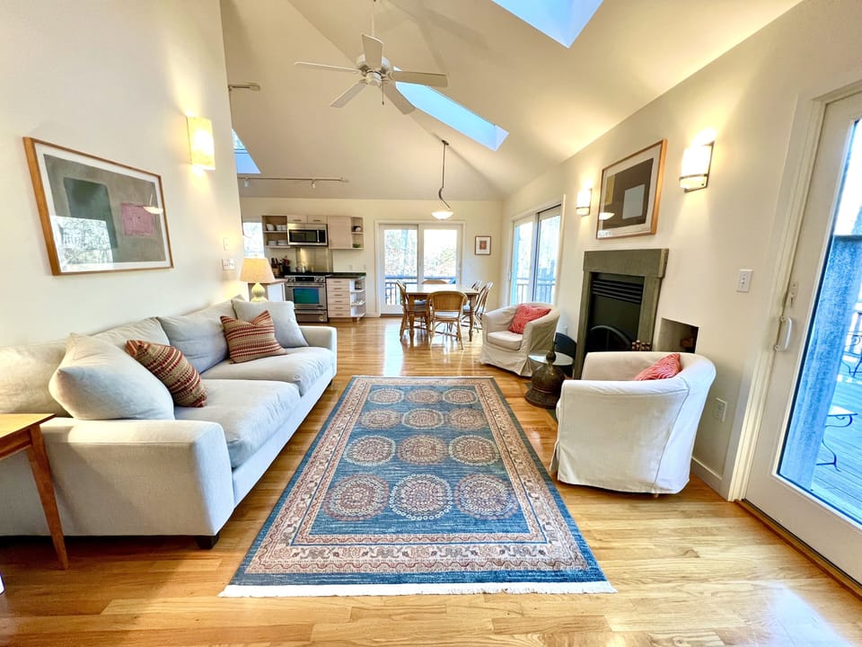 Bright & airy living area with multiple skylights & sliders that open to lg deck