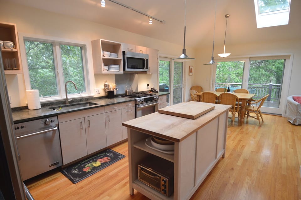 view from bright, light-filled kitchen to dining area beyond
