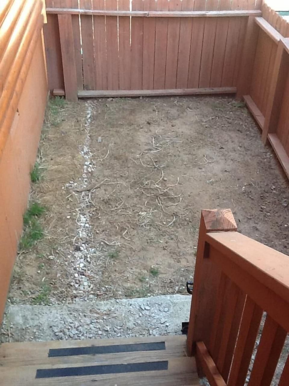 Small fenced in area off of side deck