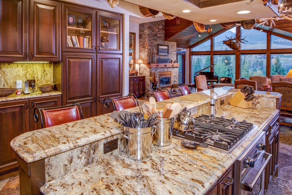 The kitchen features Viking appliances, marble countertops, & gorgeous views!