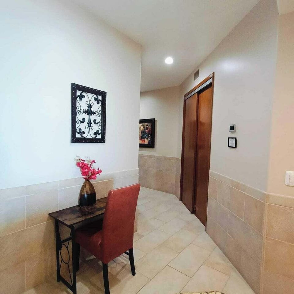 Entry hallway.  Beach chairs and umbrella in the closet.  Small computer desk.