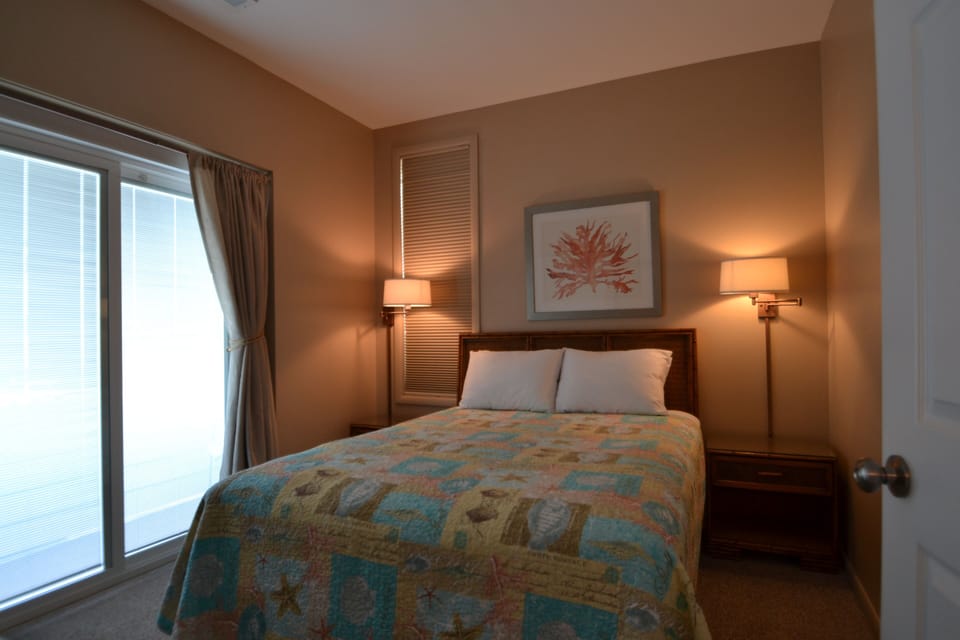 First floor bedroom with queen size bed and private deck.