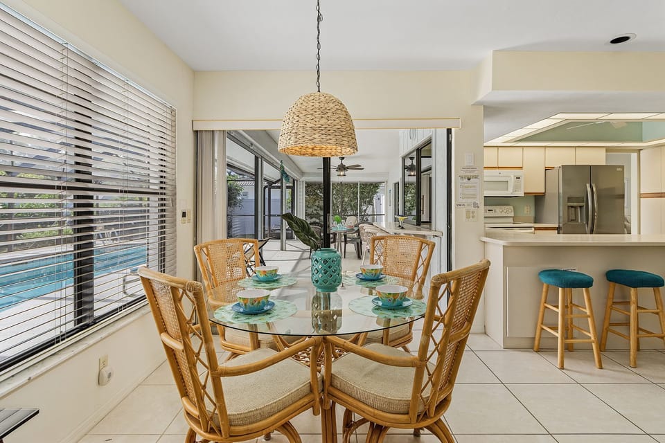 Dining area in the Kitchen/Family room has a beautiful pool view and sliders  