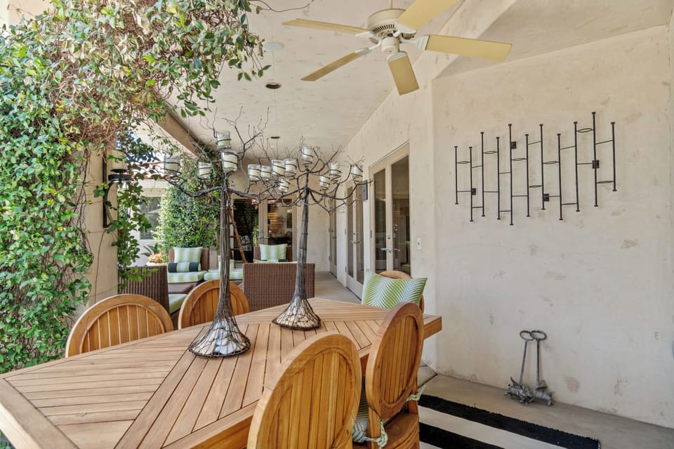 Covered outdoor living area with multiple French doors to access.