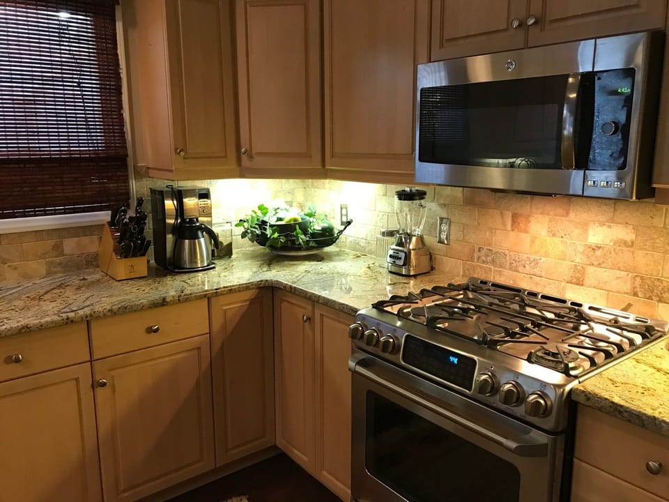 Kitchen features 5 burner gas range, convection oven and full size microwave.