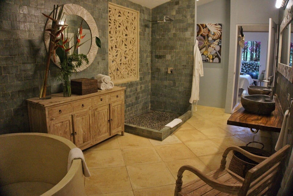 The main bath has dual sinks, a shower and large stone tub.