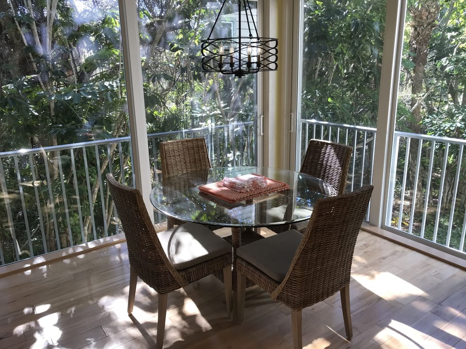 Open the sliders to dine with the birds in the large porch.