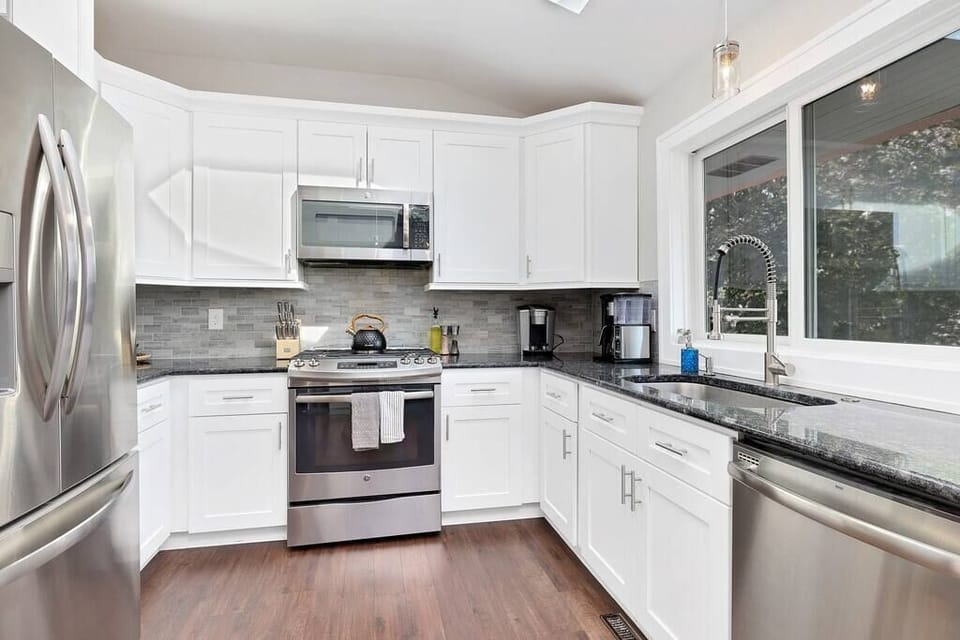 Main level kitchen with all the supplies you'll need such as sugar and spices as well as enough dishes, silverware, pots, and pans for any size gathering!