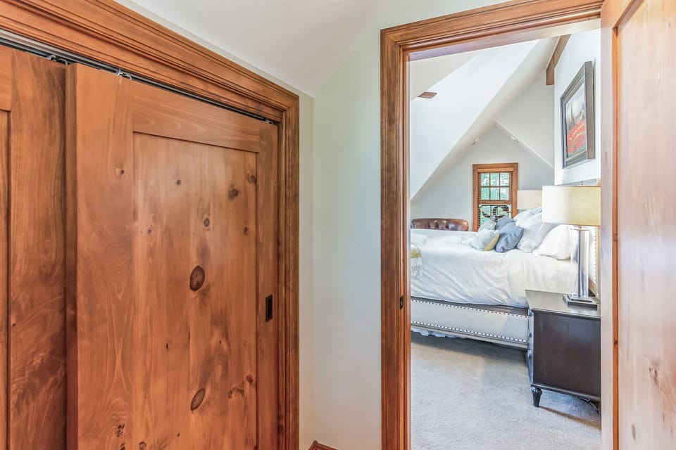 Entry to master bedroom with large hanging closet on left