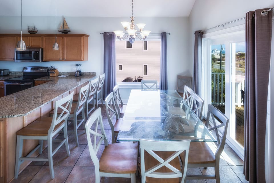 Plenty of seating for 10 at the table and 4 more at the bar!