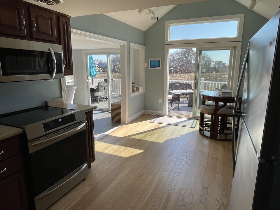 Kitchen with new appliances, to include an induction stove. 2nd slider to deck