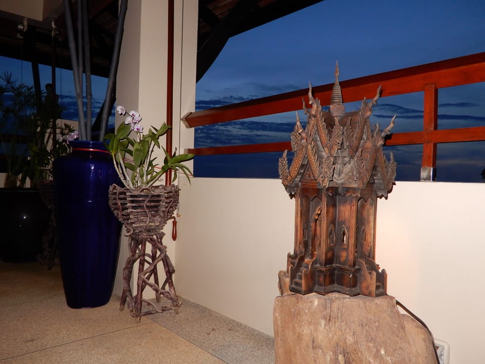 A traditional Thai home within our home in front of our day beds on the balcony