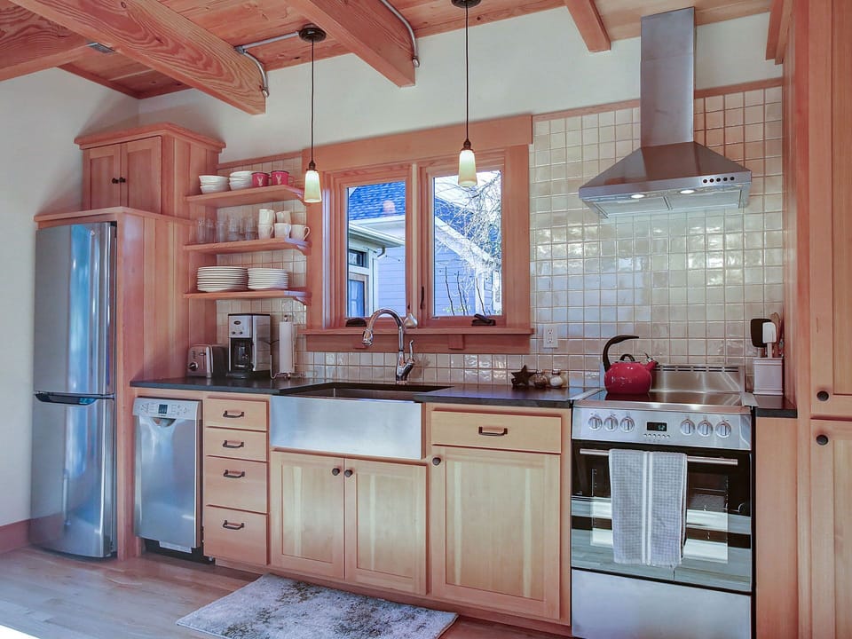 kitchen looks out into garden and plum, cherry, and apple trees