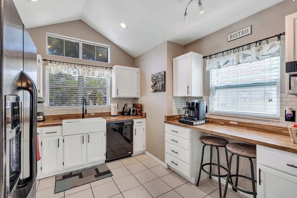 Newly renovated farmhouse kitchen complete with butcher block counter tops, white farmhouse sink, breakfast nook, Keurig Duo coffee & k-cup machine, tea kettle, coffee bar and fully stocked with plates, bowls, cups, utensils, appliances & pots/pans!