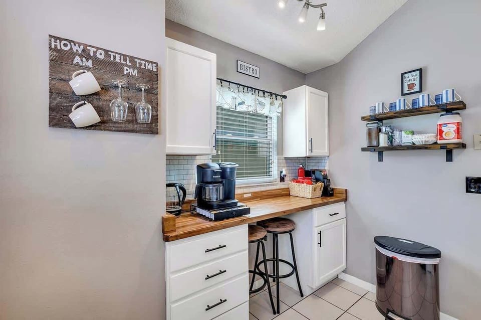 Newly renovated farmhouse kitchen complete with butcher block counter tops, white farmhouse sink, breakfast nook, Keurig Duo coffee & k-cup machine, tea kettle, coffee bar and fully stocked with plates, bowls, cups, utensils, appliances & pots/pans!