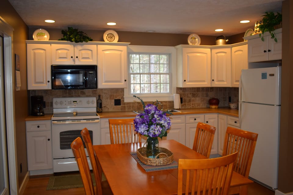 Kitchen/Dining Area  Table opens to seat 10.  Additional chairs are in basement.