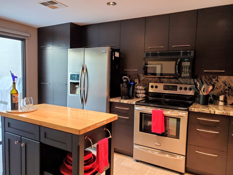 New fridge and glass-topped stove complement an efficient kitchen.