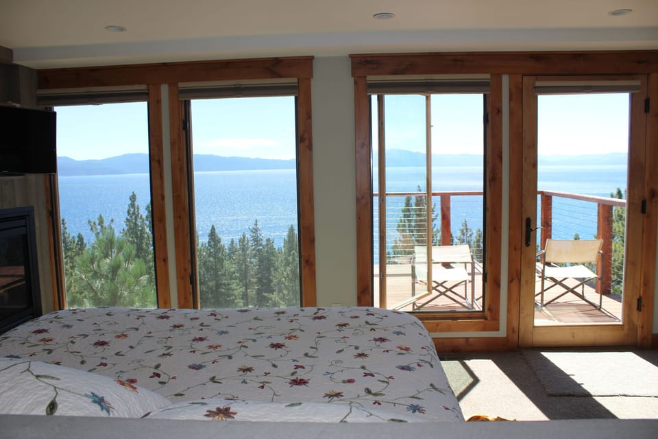 Master bedroom with panoramic lake views and private deck