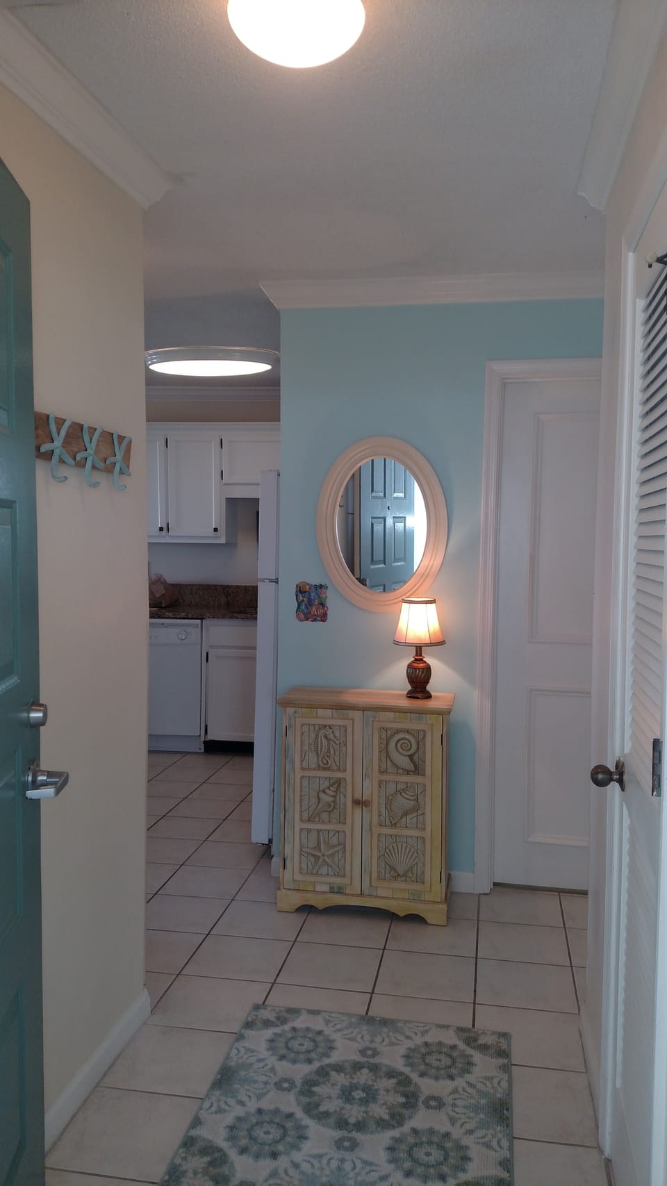 Inviting entrance hall with storage closet sets the beach tone
