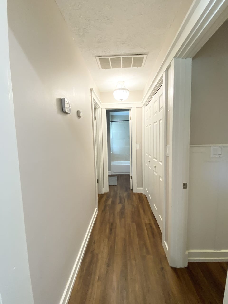 Hallway with primary br on the right, guest br on the left end of hallway 