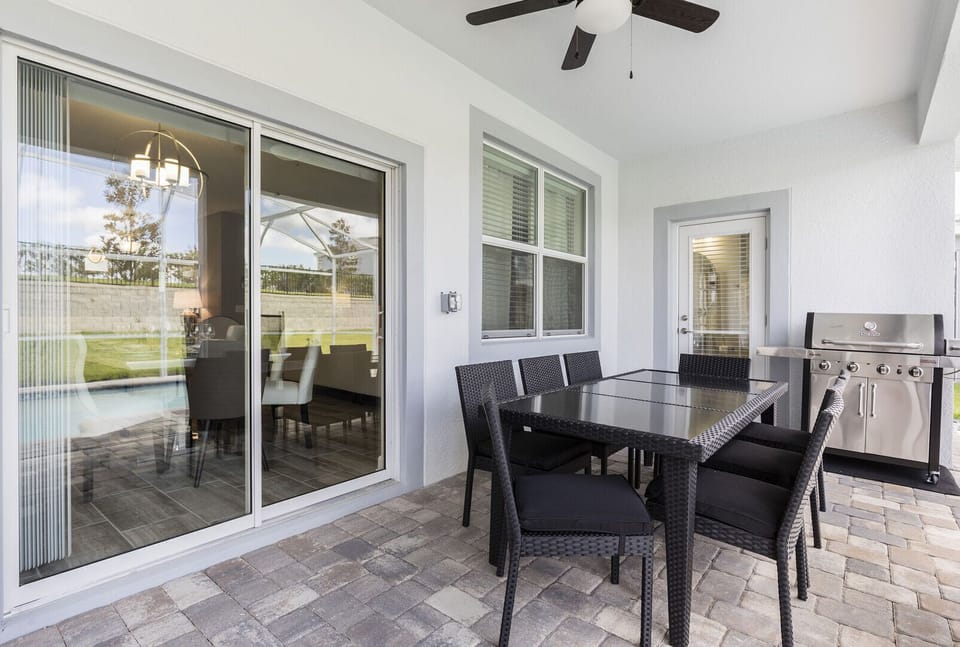 sitting area beside pool with grill