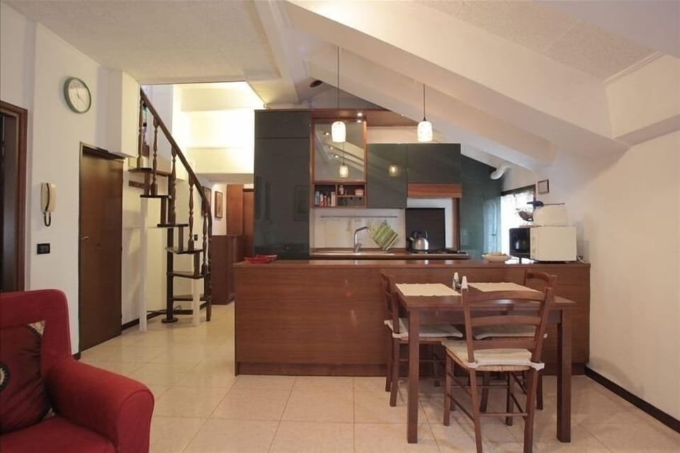 The fully-equipped open kitchen faces the living room