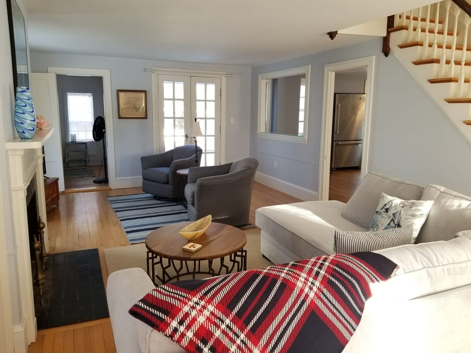 Living room with kitchen entrance on the right