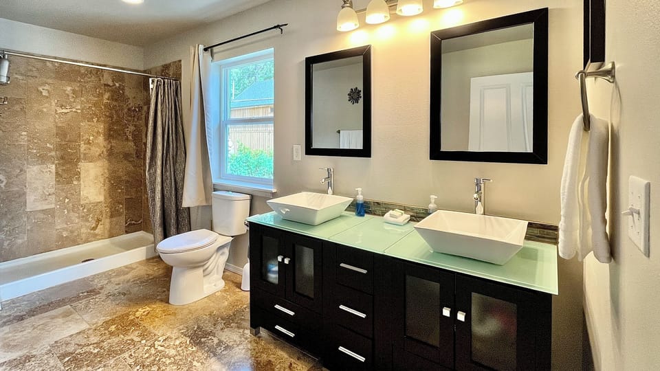 Upper floor master bedroom with large tiled travertine shower and double sinks